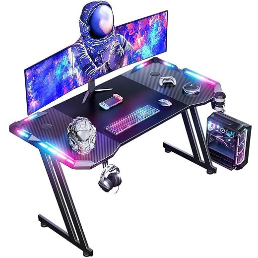 120 × 60cm LED Mesa Gaming, Escritorio Gaming de Fibra de Carbono Ergonómicas, Escritorio Gamer con Portavasos y Gancho para Auriculares, Negro