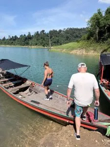 Couple boarding a long tail boat at the Cheow Lan Lake in Khao Sok.