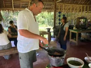 Foreigners cooking at a Thai cooking class in Khao Sok.