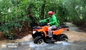 Tourist crossing a river during the ATV Adventure Tour in Khao Sok.