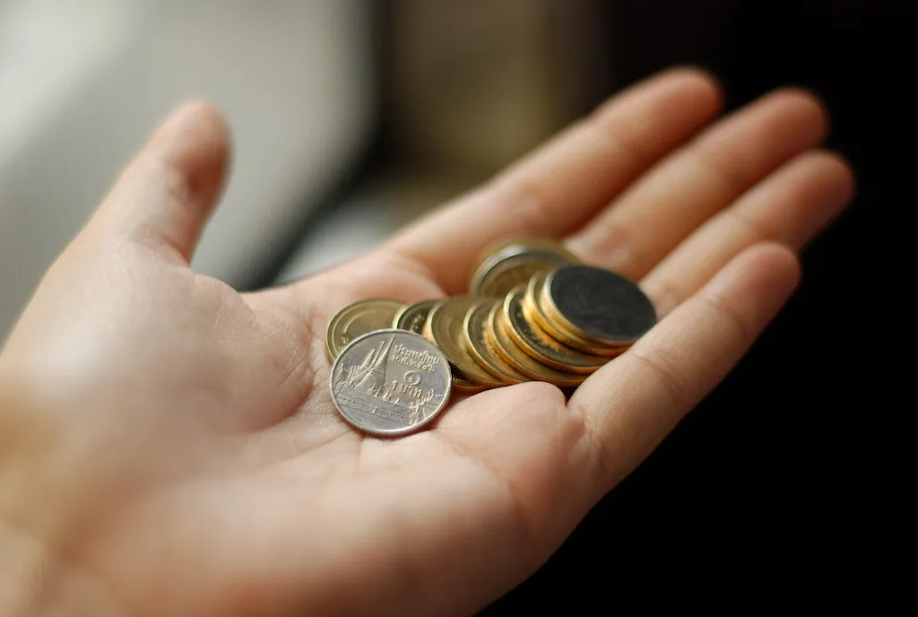 A handful of Thai baht coins