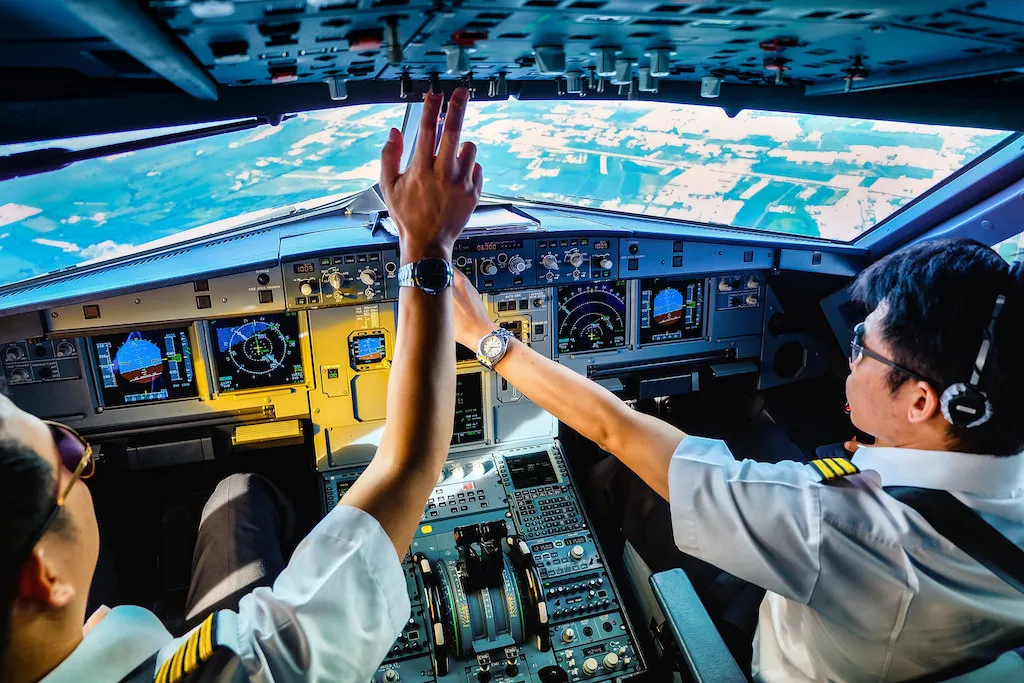 Thai Smile Airways pilots in the cockpit on duty In Thailand. Airbus A320-232(WL)