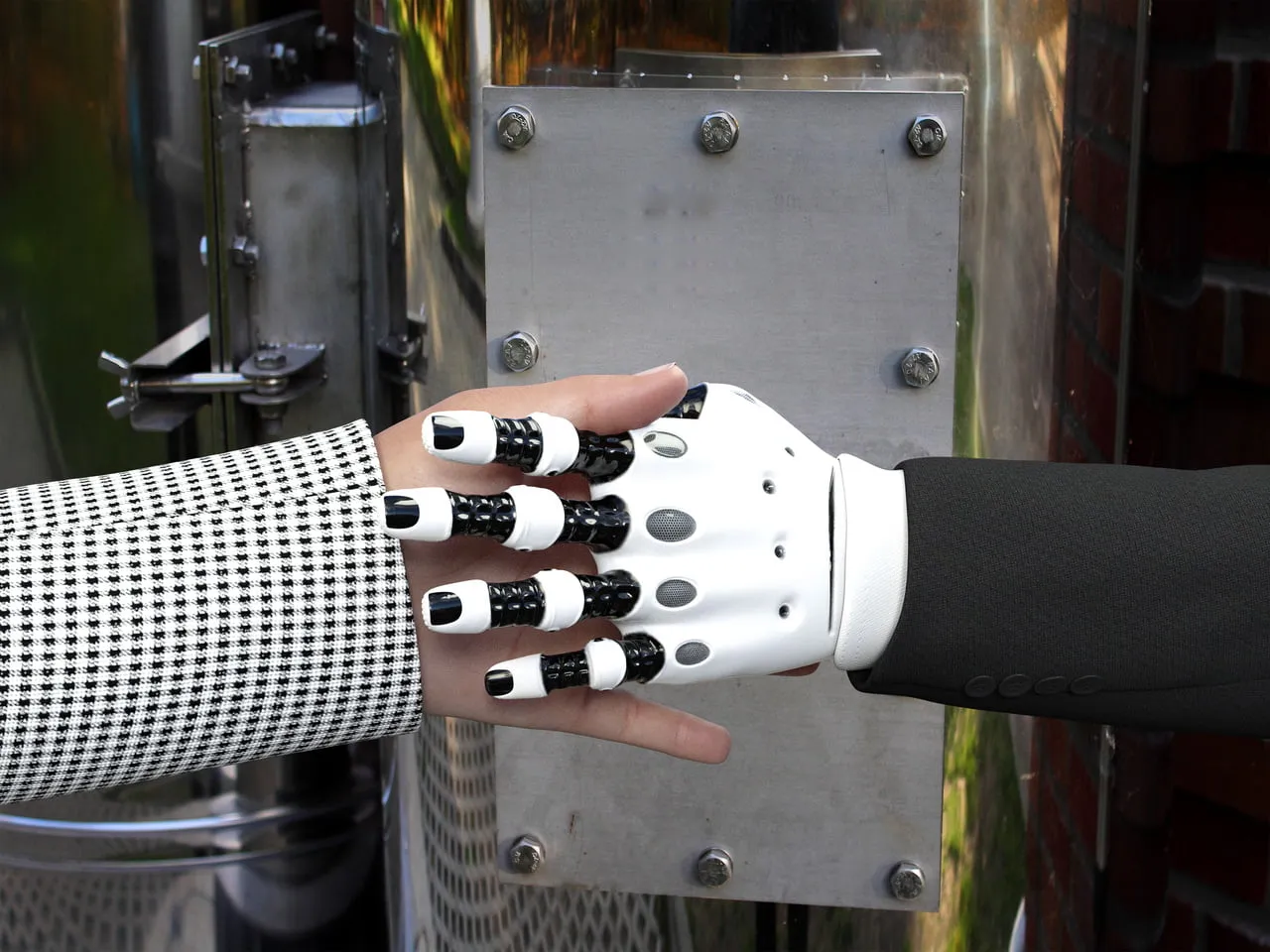 Artificial Intelligence (AI) Robot and Human shaking hands.