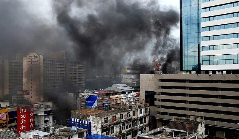 Black smoke from burning tyres in front of Lumpini Tower on Rama 4