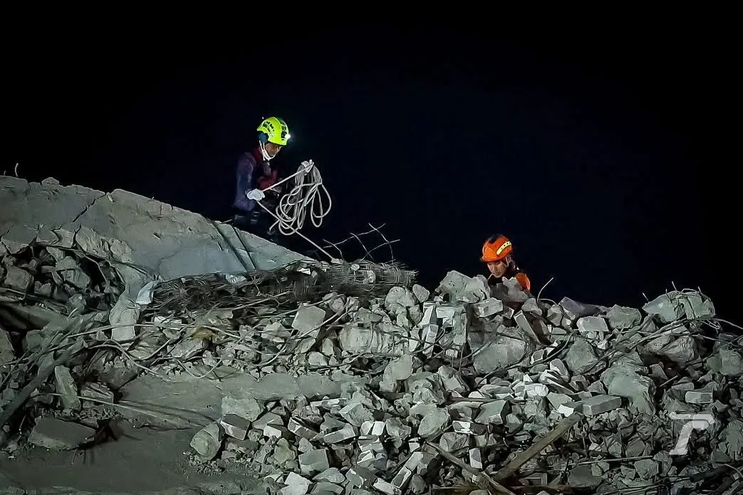 Night-time rescue operations at collapsed Bangkok quake building.