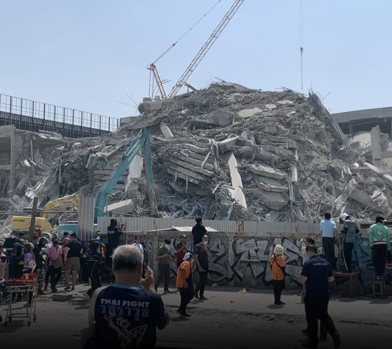 Rescue workers are using K9 dogs to search for trapped construction workers beneath the rubble of the collapsed State Audit Office building in Bangkok’s Chatuchak district.