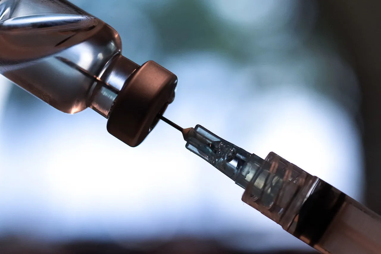 COVID-19 vaccine vial and syringe
