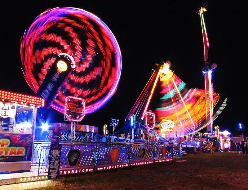 Carnival ride and Ferrys Wheel at a fair