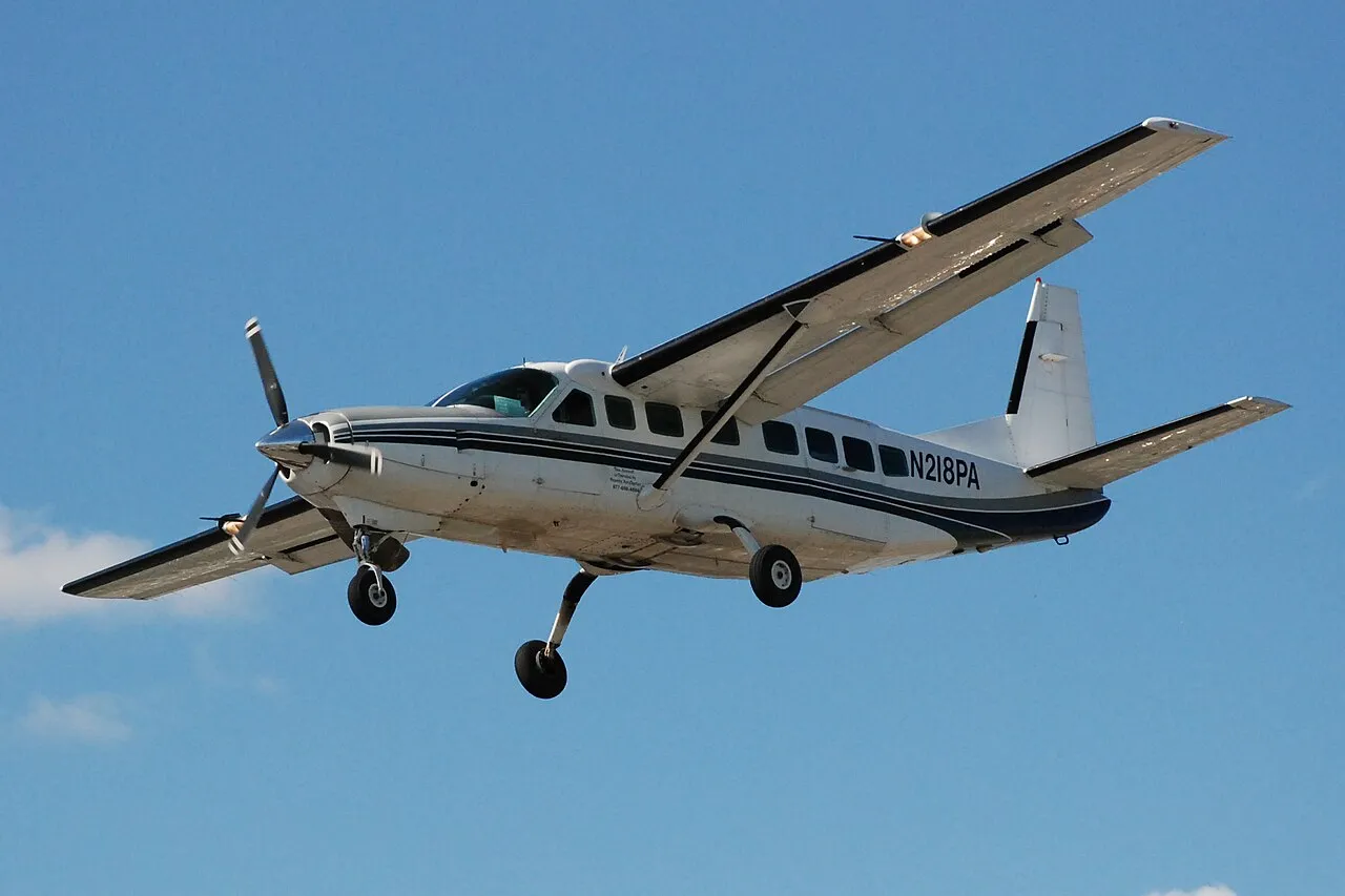 Small single propeller passenger Cessna 208 Caravan plane landing.