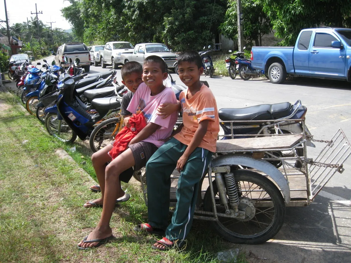 Thai children in a motorcycle sidecar