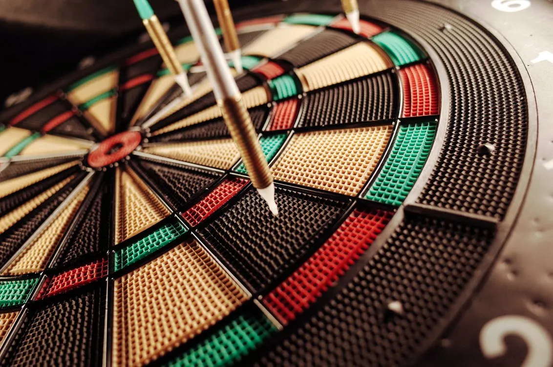 Four darts on a dartboard