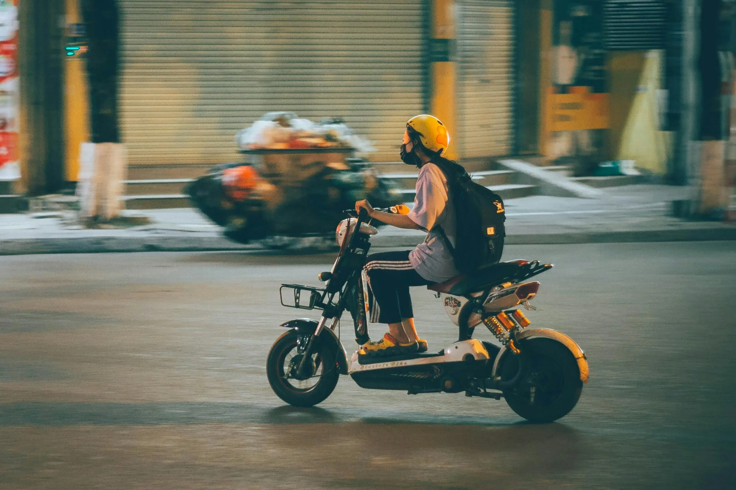 Person riding a electric scooter in Thailand.