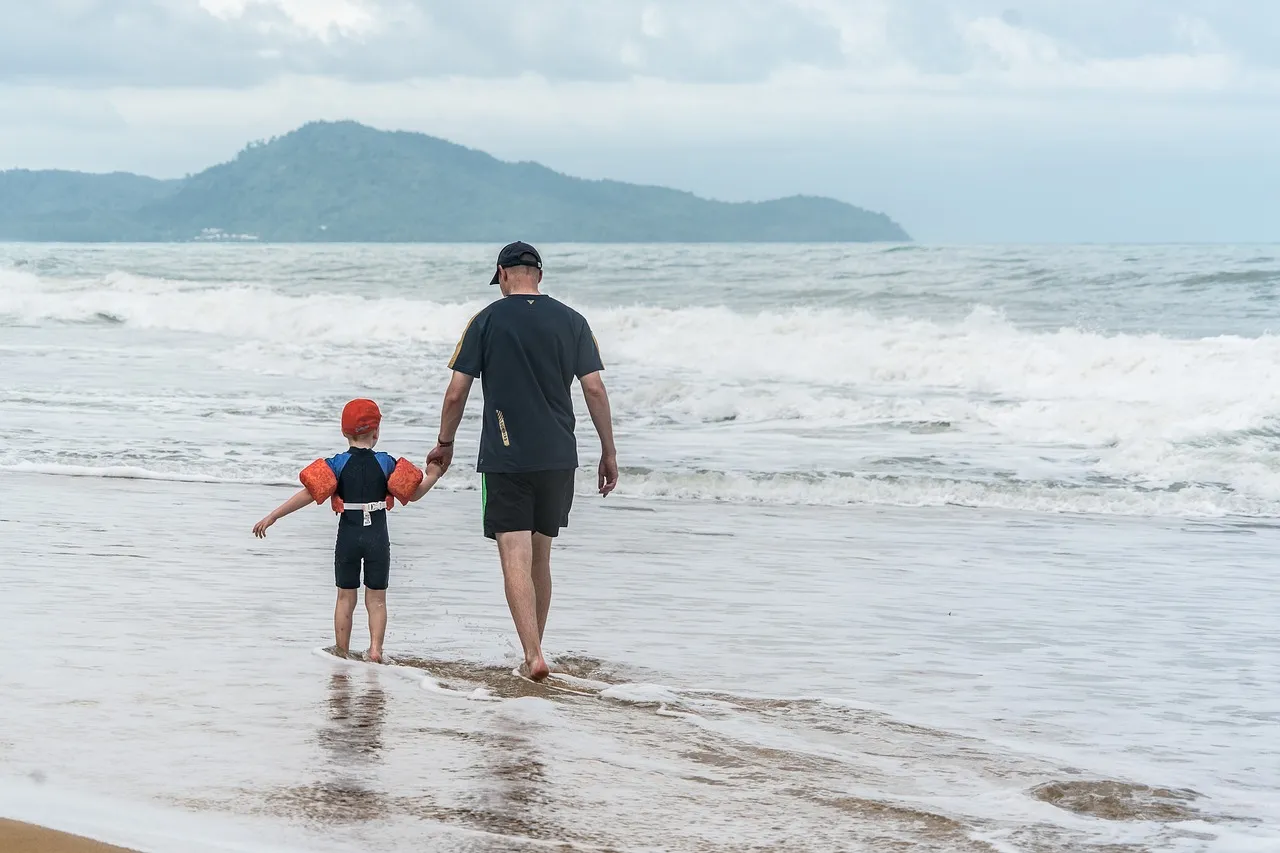Father and son on Phuket beach