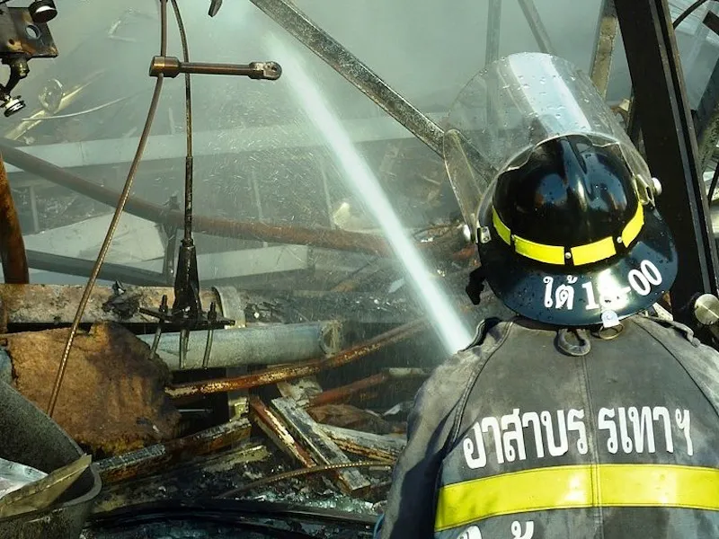Thai firefighter spraying water