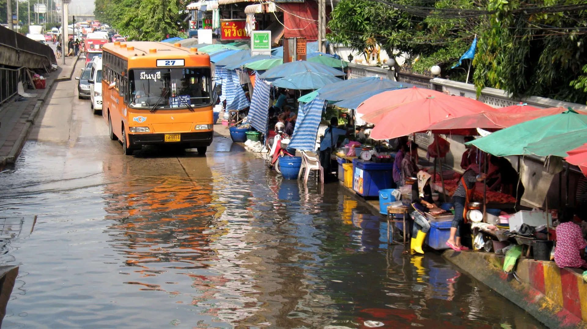 Bus crossing a street during flooding in Minburi, Bangkok.