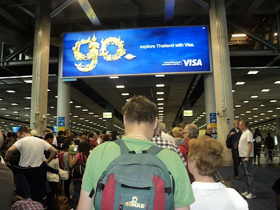 Tourist queue at Bangkok's Suvarnabhumi airport immigration.