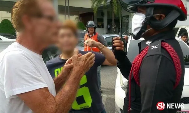 72-years-old foreigner talking to a police officer