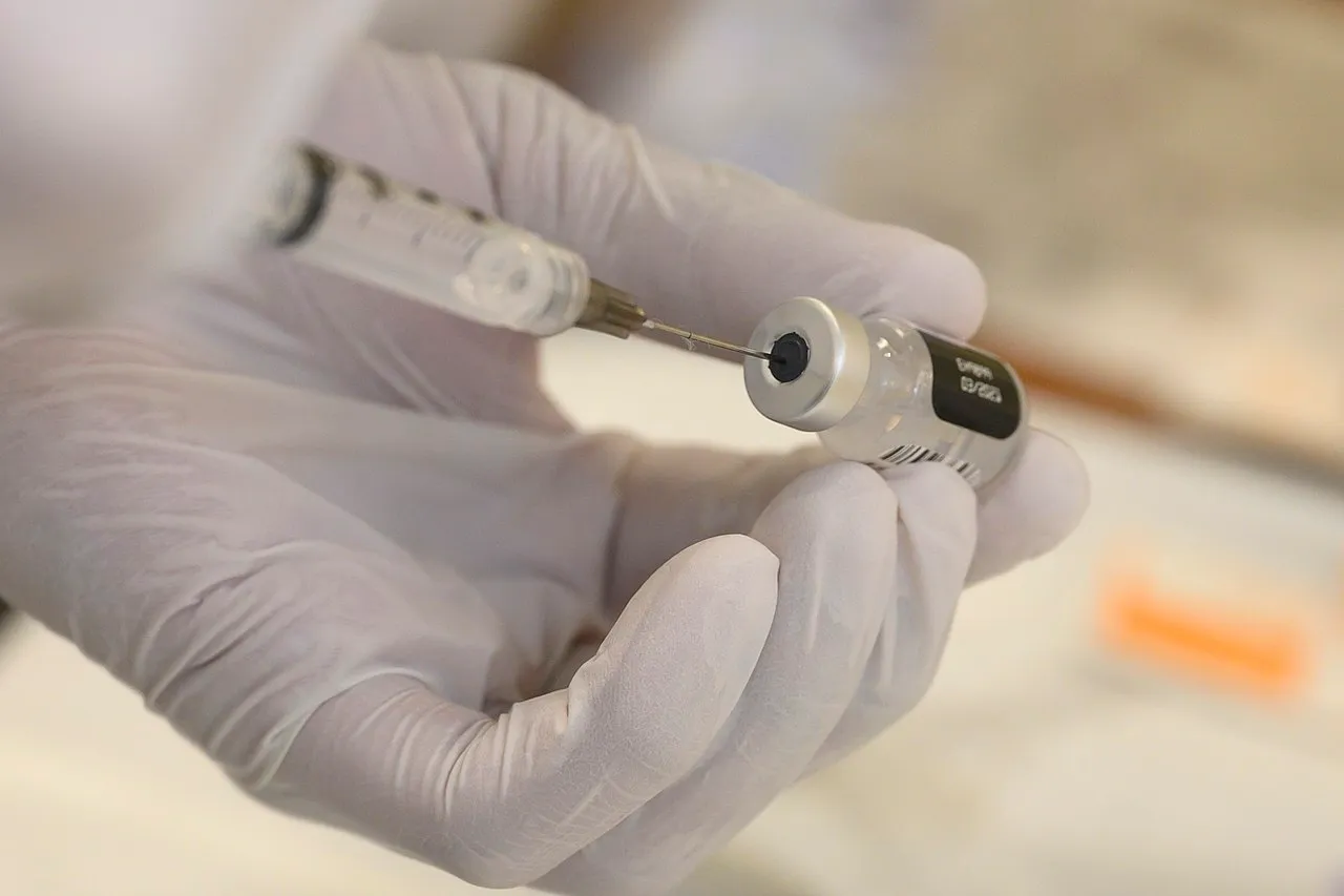 A hospitalman, prepares a dose of the COVID-19 vaccine to be administered to a patient