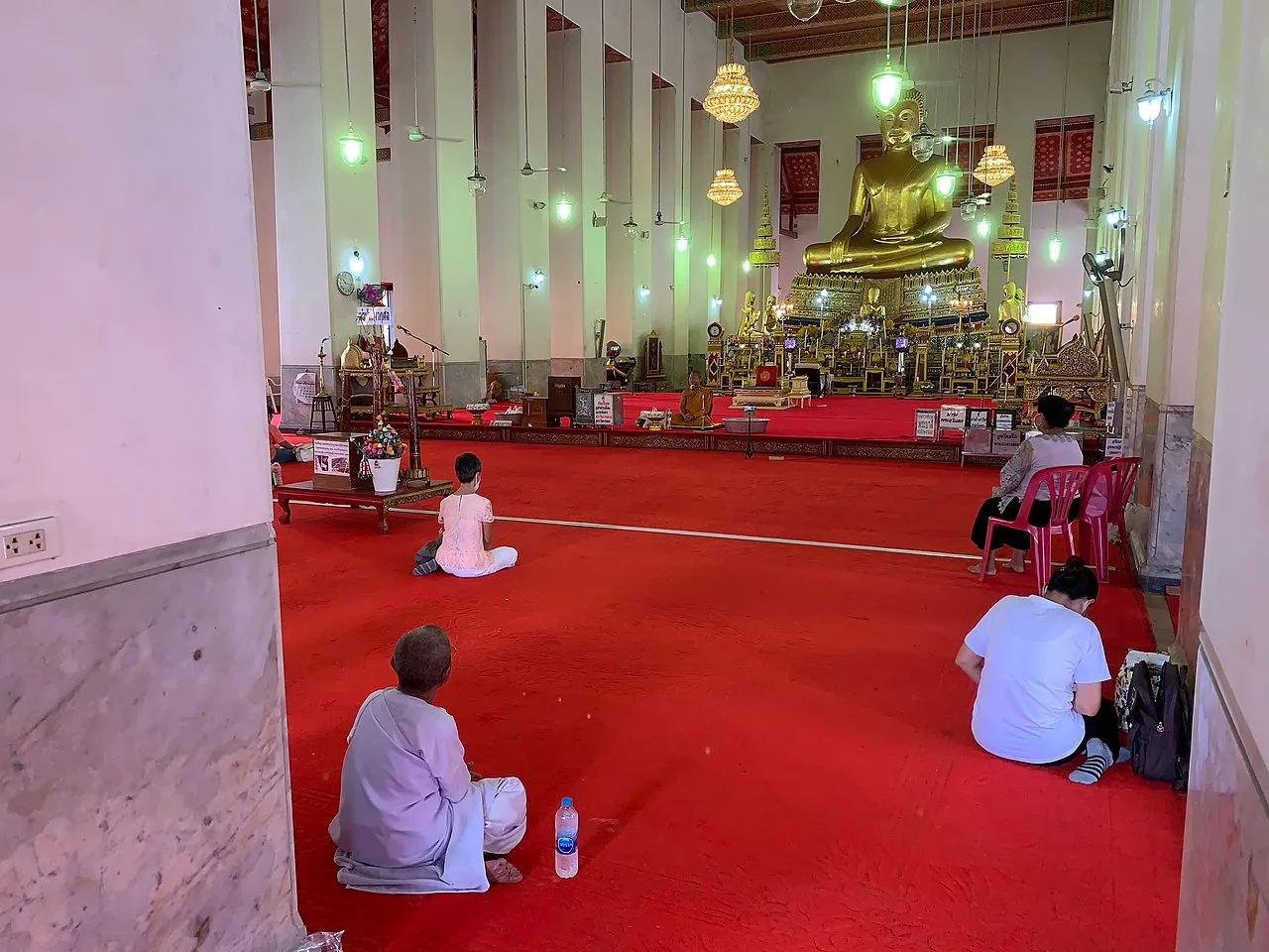 Buddhists keeping physical distance during COVID-19 at Wat Mahathat Yuwarat Rangsarit, Bangkok on the Buddhist Atthami Bucha day