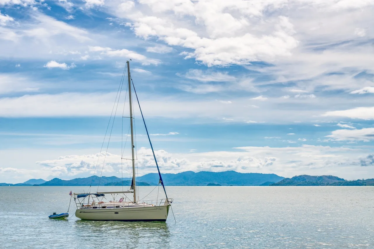 A sailboat sailing through the coast in Thailand