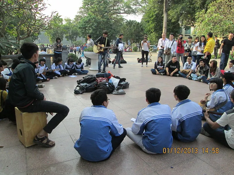 Young boys and girls singing in "Indira Gandhi Park" which has the prominent statue of Nguyen Emperor Ly Thai To