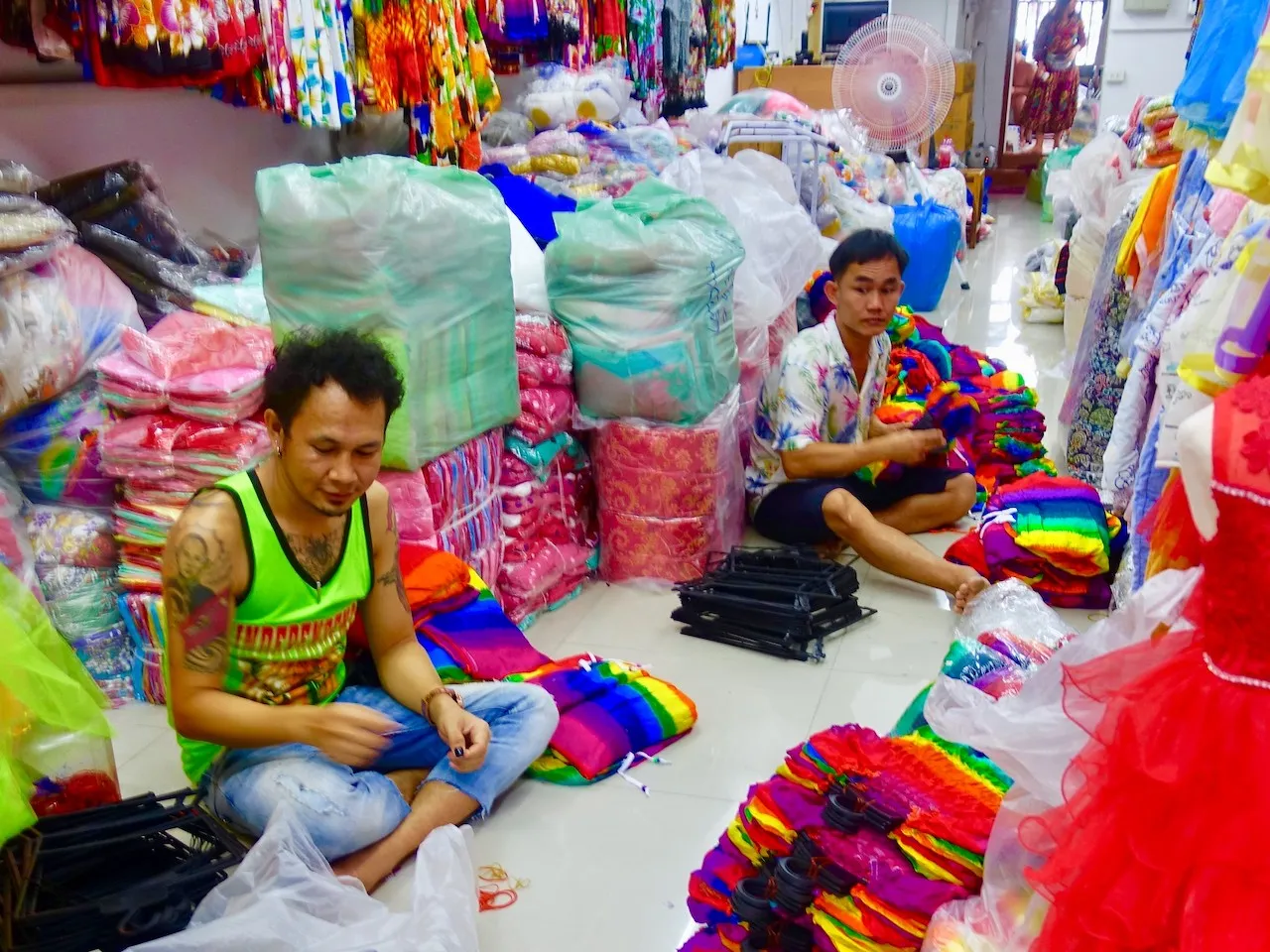 Vendors sitting in front of their products at Bo Bae Market in Bangkok.