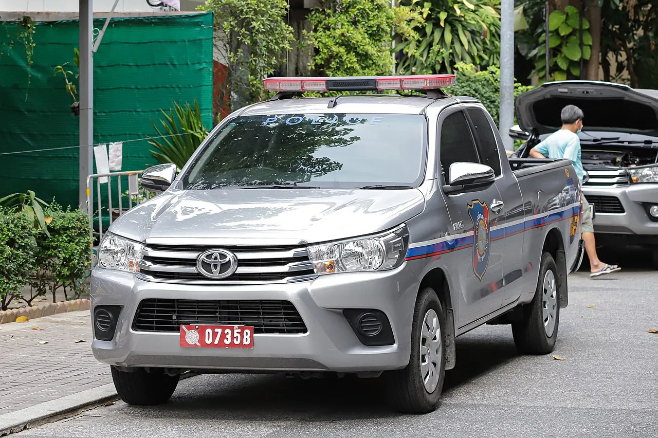 Thai Tourist Police vehicle at Rama VIII Bridge in Bangkok.