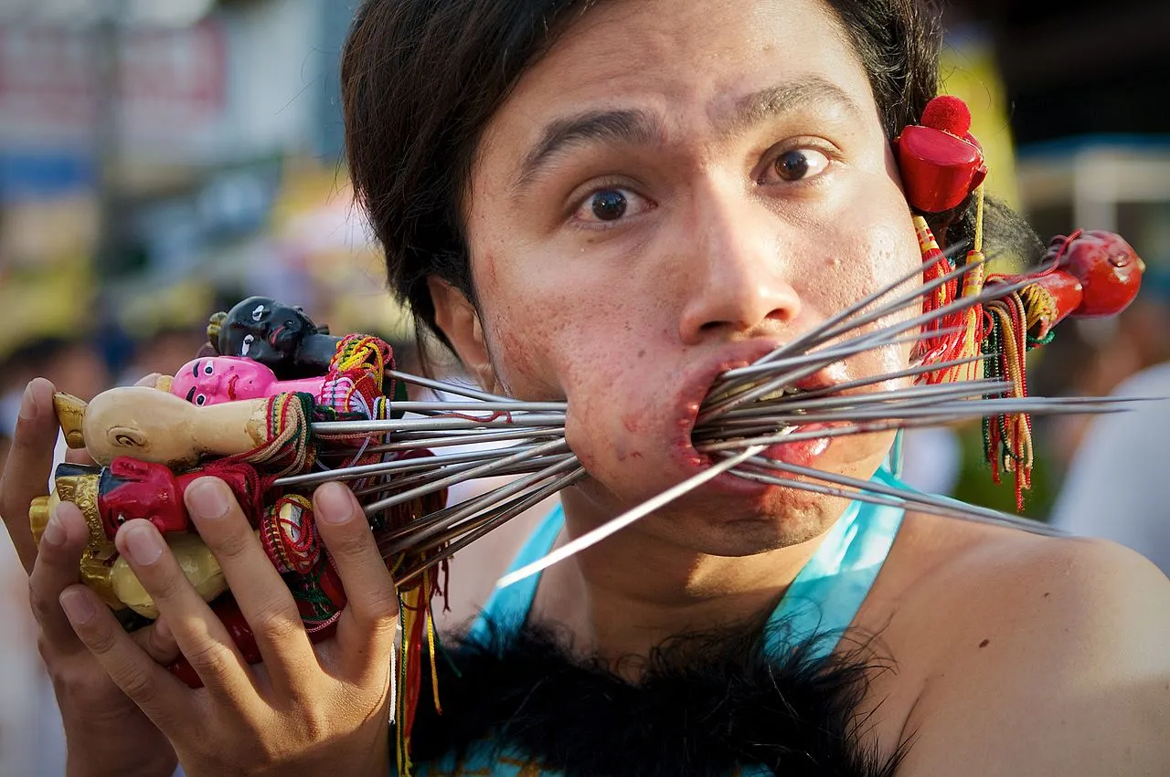 Face Piercing at Bang Neow Shrine street procession during Phuket Vegetarian Festival