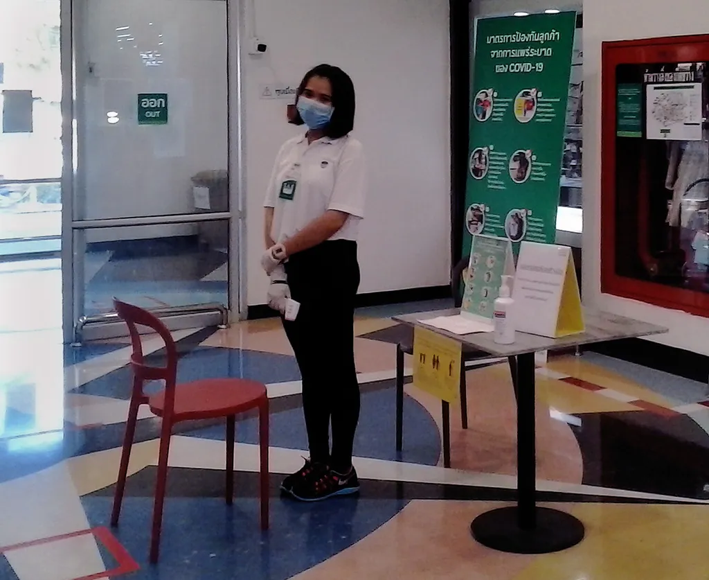 COVID-19 checking point at shopping mall entrance, temperature check and hand gel. Tesco-Lotus in Koh Samui