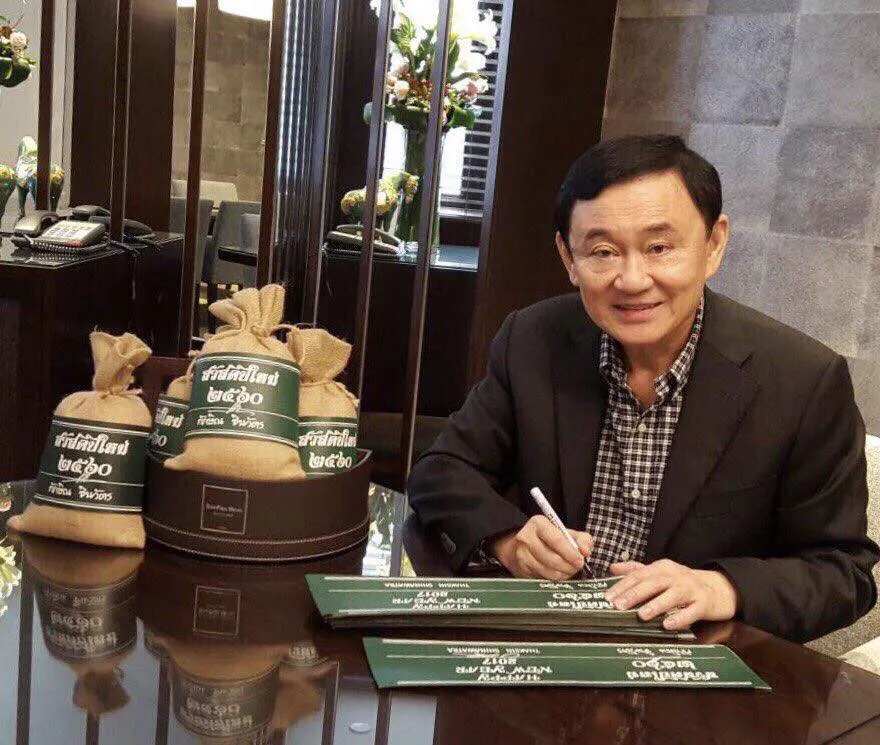 Former Thai PM Thaksin Shinawatra showing Thai rice bags