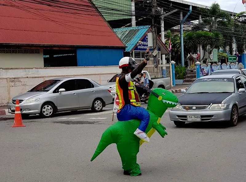 Traffic police appears to ride a dinosaur in Nakhon Nayok