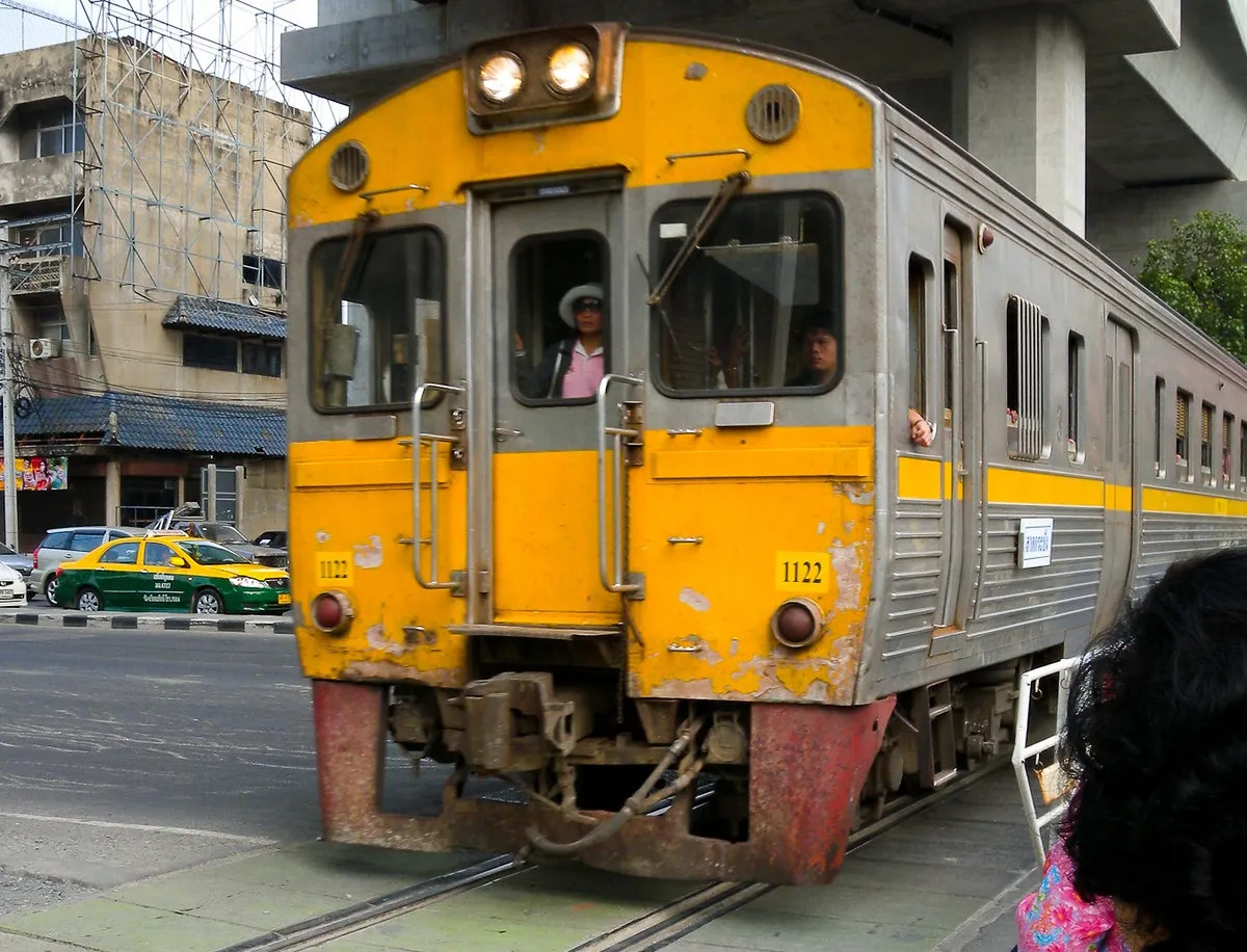 Train crossing Asok-Din Daeng Road at Makkasan Station. The Airport Link trains run above