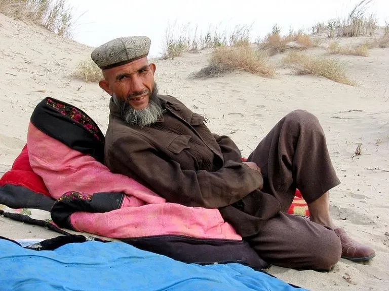 Uyghur camel guide in Taklamakan desert near Yarkand, autonomous region of Xinjiang, China
