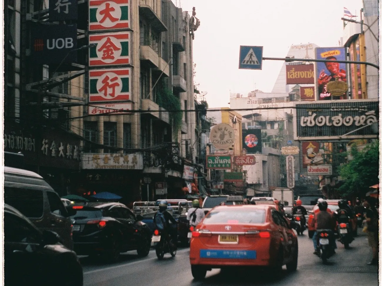 A taxi and motorcycles in Yaowarat Road, Bangkok.