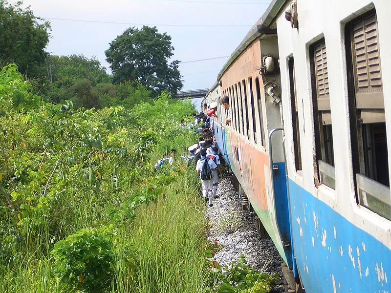 Thai Schoolchildren boarding a train