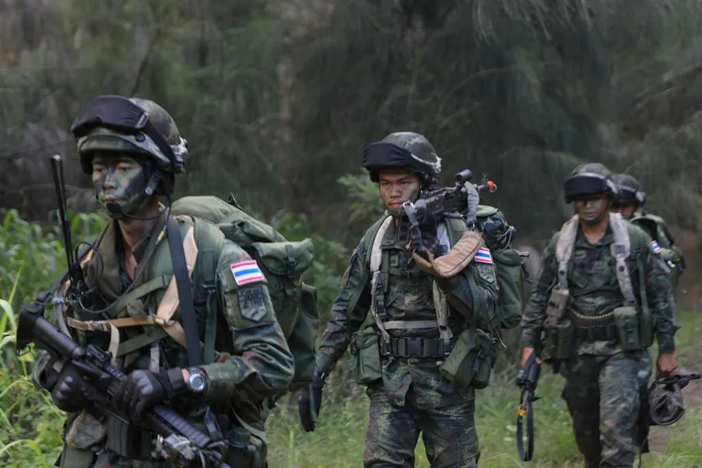 Soldiers from the Royal Thai Army patrol through the jungle.