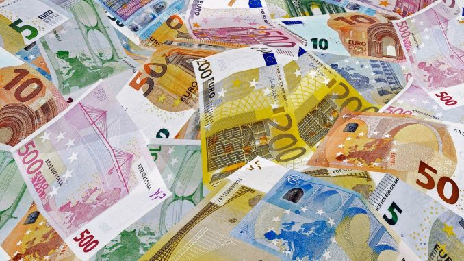 Bunte Euro-Banknoten in verschiedenen Währungen und Farben, die Geldscheine in Euro-Designs, die auf einem Tisch liegen, symbolisieren Finanzthemen und wirtschaftliche Diskussionen.