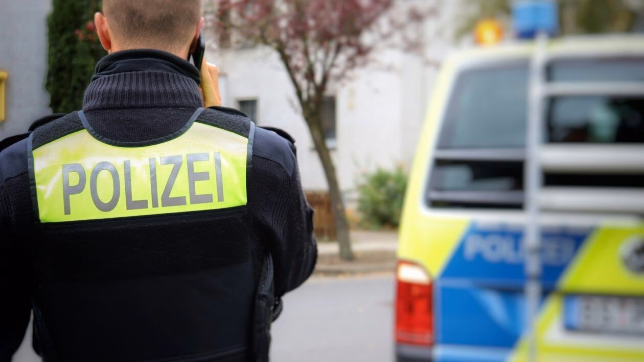 a police officer standing in front of a police car